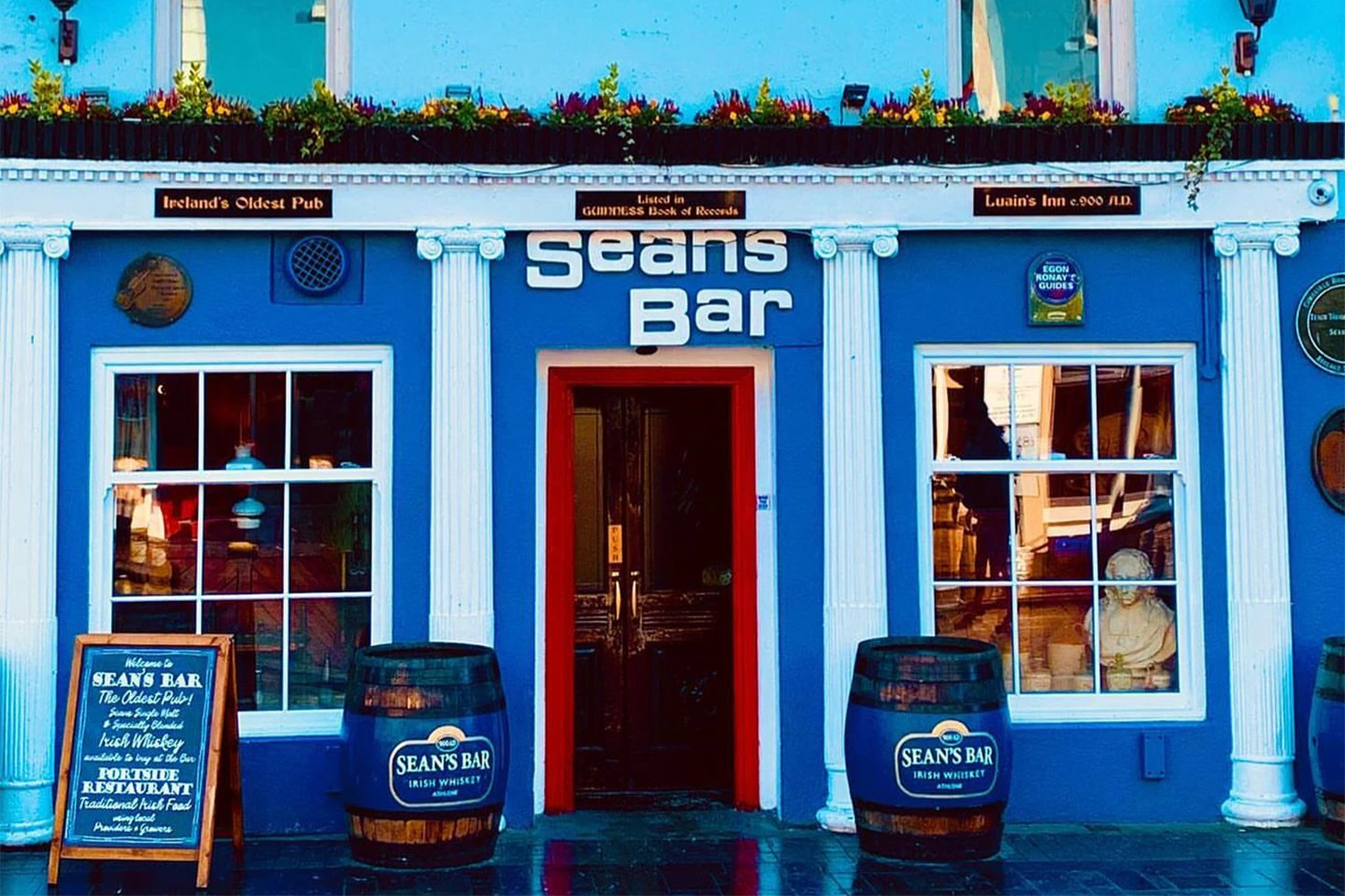 The vibrant blue and yellow exterior of Sean's Bar, Ireland's Oldest Pub.